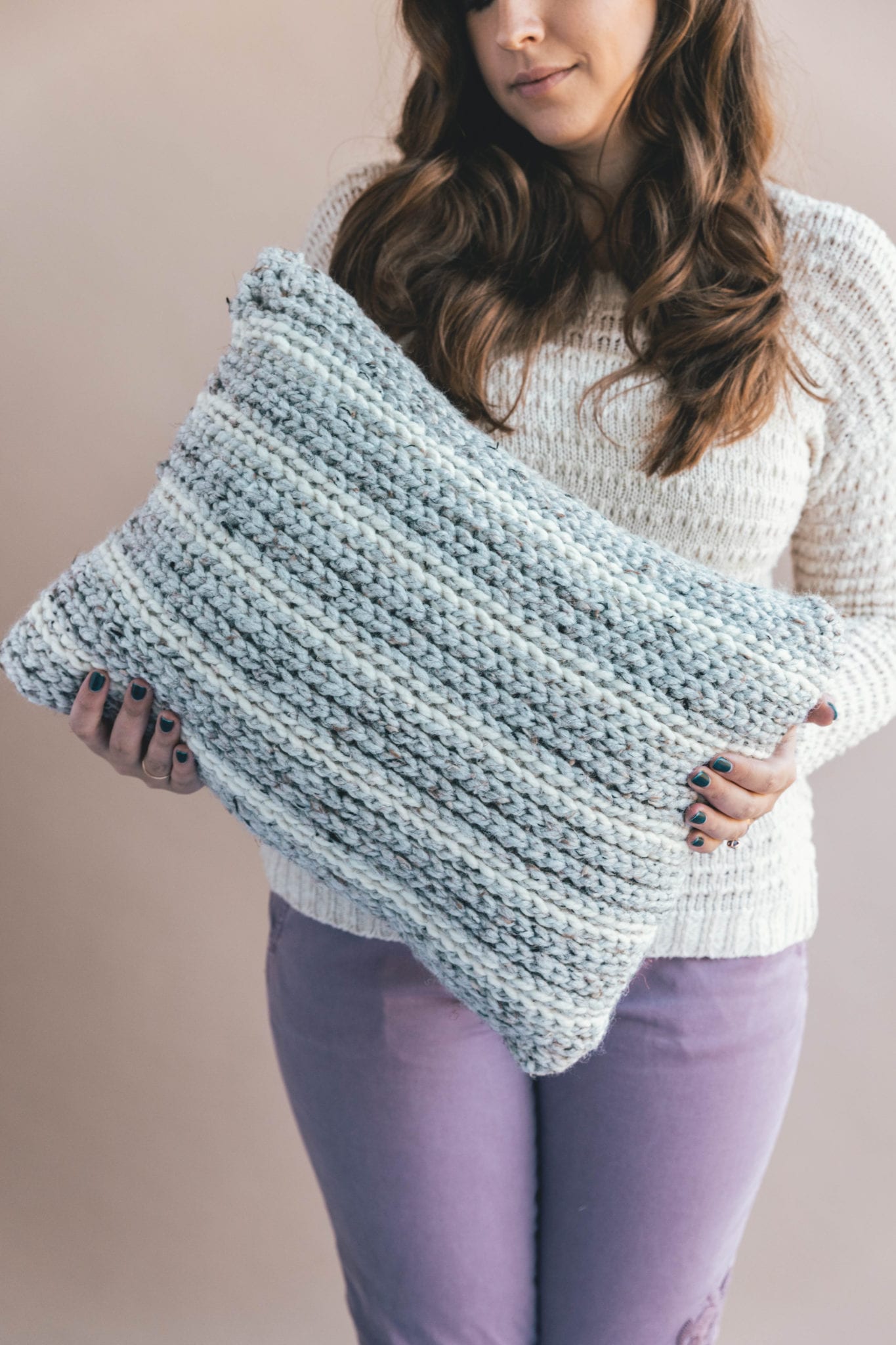 Knit Look Pillow held by a woman