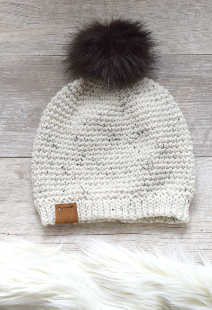 Single Crochet Hat with a faux fur puff on a table